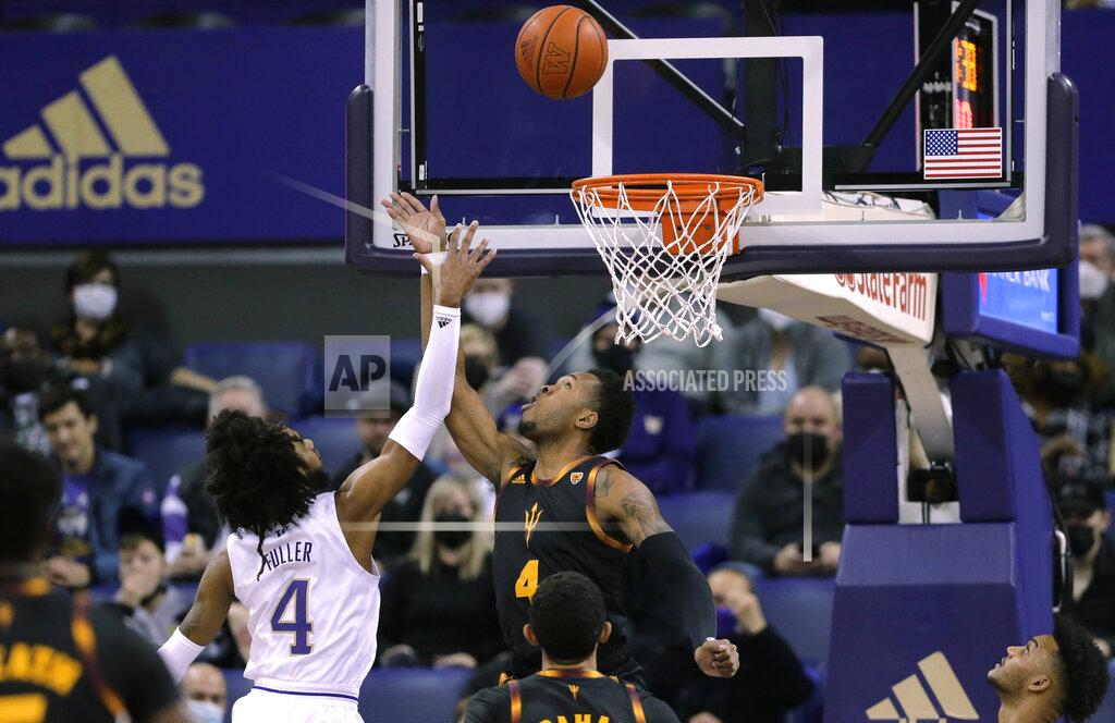 John Froschauer Arizona State's Kimani Lawrence tips the ball in for a basket as Washington's PJ Fuller defends during the first half of an NCAA college basketball game Thursday, Feb. 10, 2022, in Seattle. (AP Photo/John Froschauer)