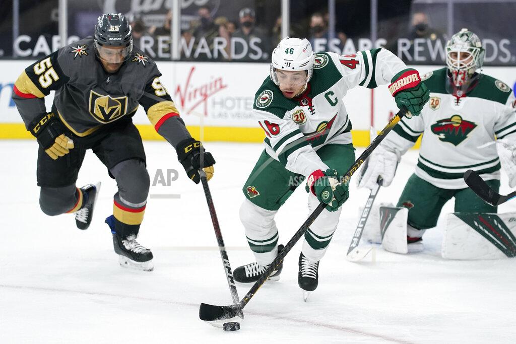 John Locher Minnesota Wild left wing Joseph Cramarossa (56) and Vegas Golden Knights right wing Keegan Kolesar (55) vie for the puck during the second period of an NHL hockey game Thursday, April 1, 2021, in Las Vegas. (AP Photo/John Locher)