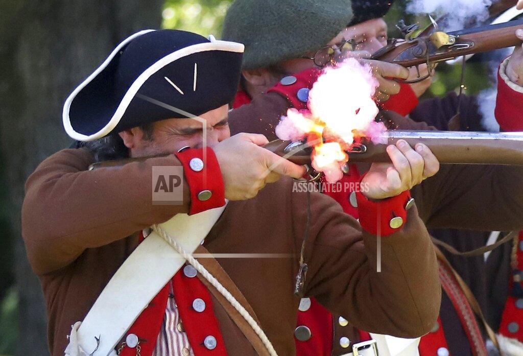 Dave Scherbenco Matt Lyons, a member of the 24th Connecticut Militia, fires his musket during the 144th annual Commemorative Service for the Battle and Massacre of Wyoming held on the grounds of the Wyoming Monument Monday July 4, 2022, in Wyoming Pa. (Dave Scherbenco/The Citizens' Voice via AP)