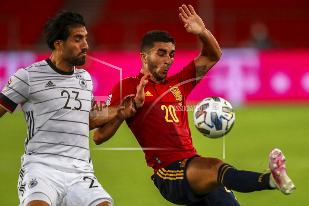 Matthias Schrader Germany's Emre Can, left, duels for the ball with Spain's Ferran Torres during the UEFA Nations League soccer match at the Mercedes-Benz Arena stadium in Stuttgart, Germany, Thursday, Sept. 3, 2020. (AP Photo/Matthias Schrader)