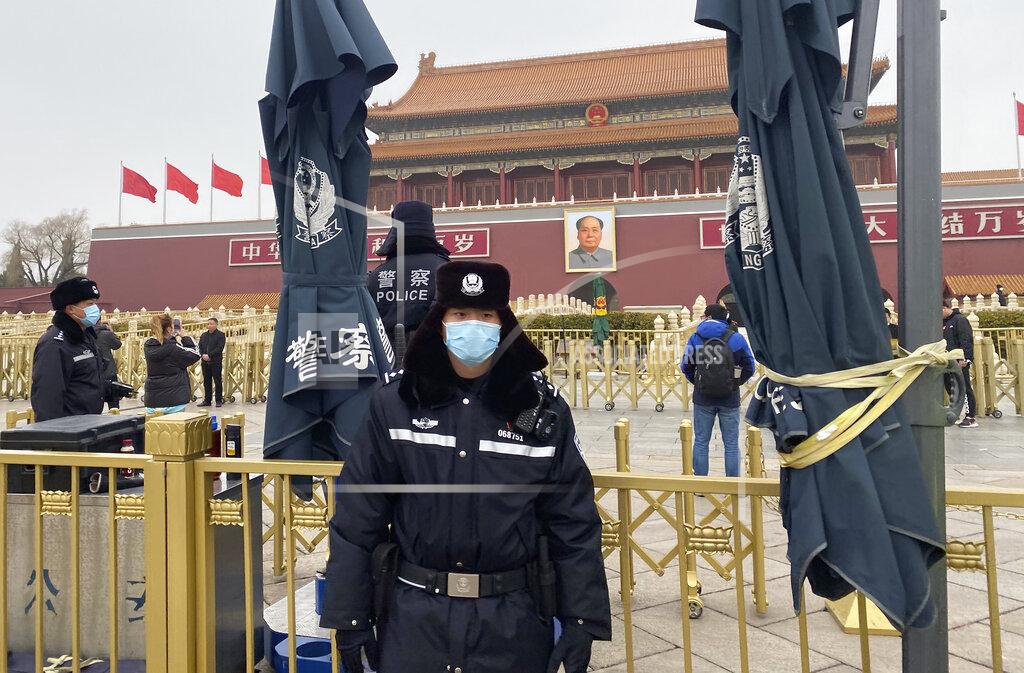 Ng Han Guan Chinese police officers stand on duty near Tiananmen Gate across from the Great Hall of the People where the annual congress meetings are expected to be held this week in Beijing Tuesday, March 2, 2021. China's legislature begins its annual meeting this week with economic growth and a further crackdown on political opponents in Hong Kong expected to be on the agenda. (AP Photo/Ng Han Guan)