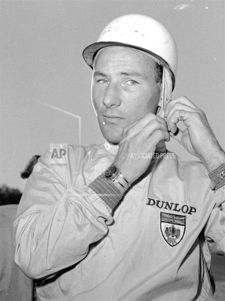 Stf FILE - In this Black and White file photo dated October 7, 1961, legendary British driver Stirling Moss at the U.S. Grand Prix at Watkins Glen, New York. Stirling Moss has died at the age of 90, according to an announcement Sunday April 12, 2020, from his family. (AP Photo/stf FILE)
