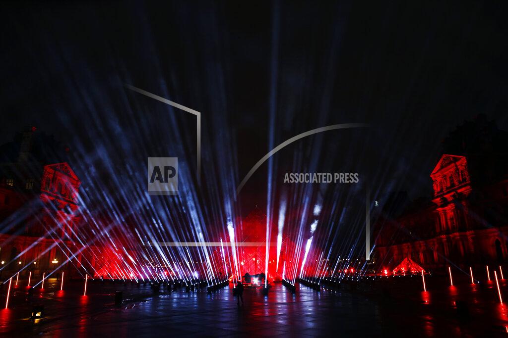 Thibault Camus The courtyard of the Louvre museum is illuminated during the rehearsal of a show by French DJ David Guetta, in Paris, Tuesday, Dec. 29, 2020. Superstar DJ David Guetta has, quite literally, been brought back to Earth by the coronavirus pandemic and says his music has benefitted as a result. Back in his native Paris to record a New Year's Eve show, the composer of ear-worm dance hits said he has produced "tons of new music" while hunkering down from the virus. (AP Photo/Thibault Camus)