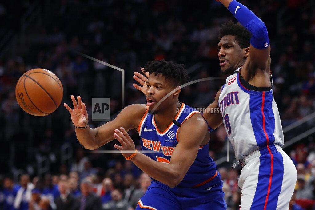 New York Knicks guard Dennis Smith Jr. passes as Detroit Pistons guard Langston Galloway (9) defends during the first half of an NBA basketball game, Saturday, Feb. 8, 2020, in Detroit. (AP Photo/Carlos Osorio)