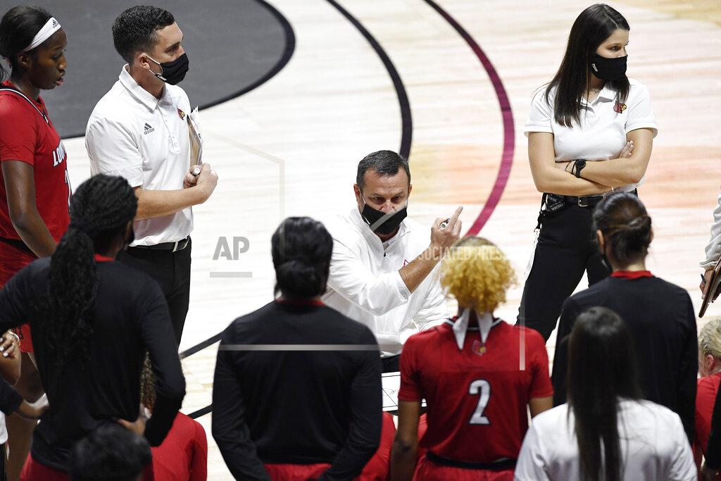 Jessica Hill Louisville head coach Jeff Walz talks to his team during a timeout in the first half of an NCAA college basketball game against DePaul, Friday, Dec. 4, 2020, in Uncasville, Conn. (AP Photo/Jessica Hill)