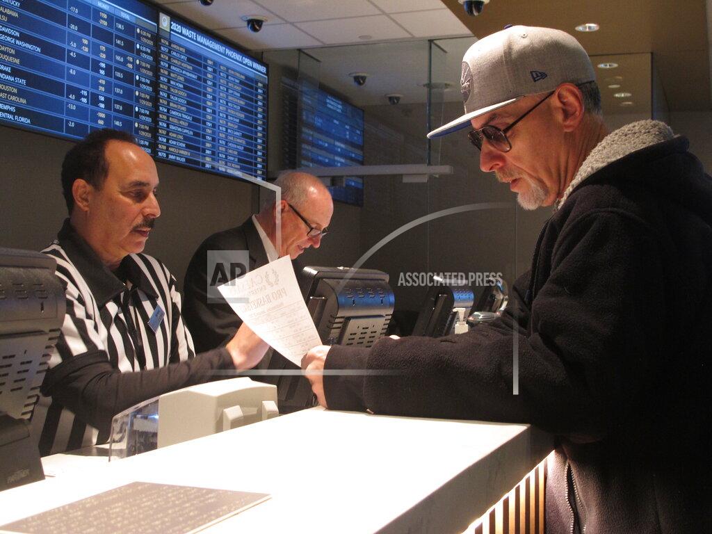 Wayne Parry In this Jan. 29, 2020, photo, a gambler makes bets on the upcoming Super Bowl at Bally's casino in Atlantic City N.J. Gambling industry officials expect Sunday's Super Bowl to be among the most heavily wagered-on championship games ever. (AP Photo/Wayne Parry)