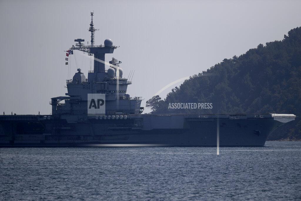 Daniel Cole The French aircraft carrier Charles de Gaulle arrives in the bay of Toulon, southern France, Sunday April 12, 2020. The Defense Ministry said in a statement that around 40 sailors showed symptoms compatible with COVID-19, the disease the coronavirus causes. The new coronavirus causes mild or moderate symptoms for most people, but for some, especially older adults and people with existing health problems, it can cause more severe illness or death. (AP Photo/Daniel Cole)