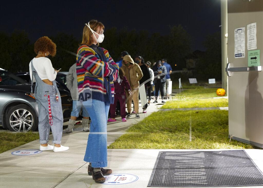 Elizabeth Conley Aubrey Calaway, 23, waits to vote in the general election outside Victory Houston polling station in Houston on Friday, Oct. 30, 2020. The location was one of the Harris County's 24-hour locations. (Elizabeth Conley/Houston Chronicle via AP)