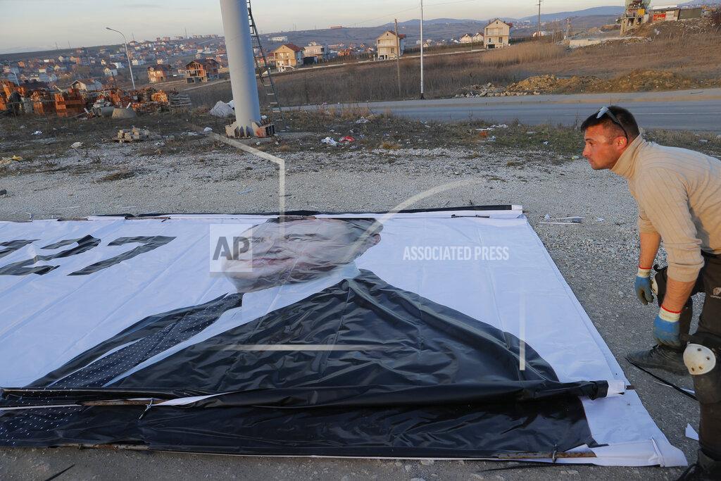 Visar Kryeziu Workers stretch a giant banner of Albin Kurti Leader of the Vetevendosje (Self-determination) political party and candidate for the prime minister in Shkabaj of Kosovo, on Friday, Feb. 5, 2021. Kosovo holds an early general election on upcoming Sunday Feb. 14, amid the coronavirus pandemic, economic downturn and stalled negotiations with wartime foe Serbia. (AP Photo/Visar Kryeziu)