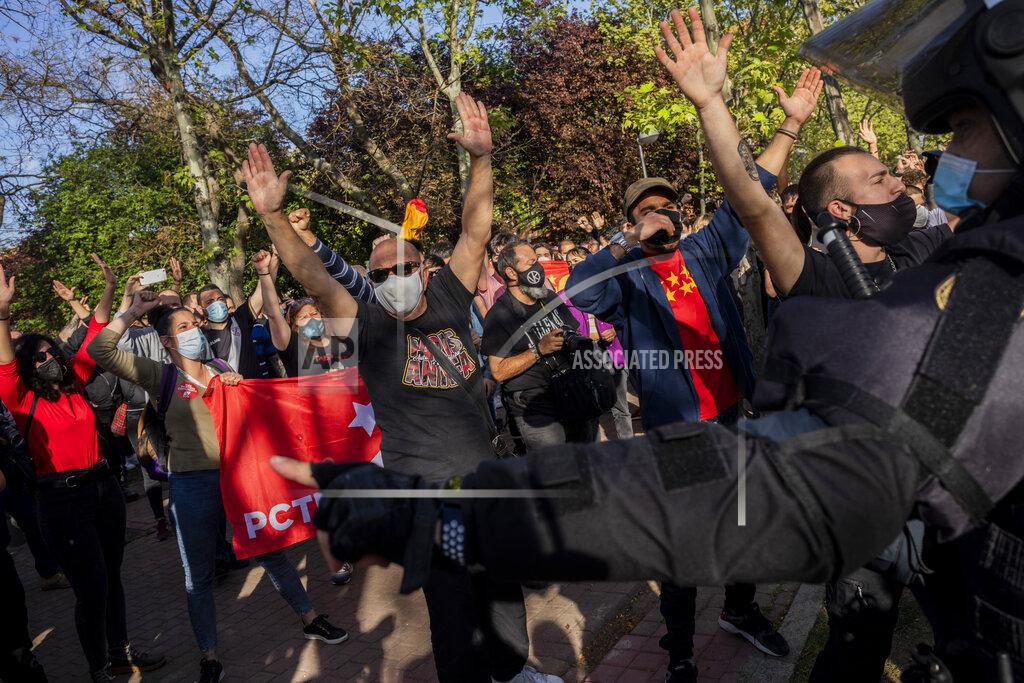 Bernat Armangue Left-wing protesters gather against a campaign event of the far-right Vox party in Madrid, Spain, Wednesday, April 7, 2021. Spanish police had to use batons on Wednesday to keep protesters away from supporters of the far-right Vox party at a campaign rally in Madrid. Scuffles started when the national leader of Vox, Santiago Abascal, approached a crowd which had gathered to protest the party rally in Madrid's working-class Vallecas neighborhood, a traditional left-wing bastion. Riot peace charged several hundred protesters to keep them away from Abascal and other members of his party campaigning for May 4 regional elections in the area including Spain's capital. (AP Photo/Bernat Armangue)