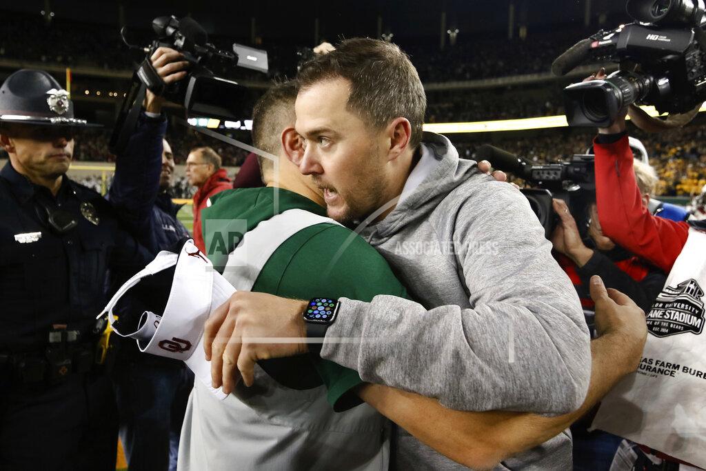 Ray Carlin Baylor head coach Matt Rhule, left, and Oklahoma head coach Lincoln Riley hug after an NCAA college football game in Waco, Texas, Saturday, Nov. 16, 2019. Oklahoma won 34-31. (AP Photo/Ray Carlin)