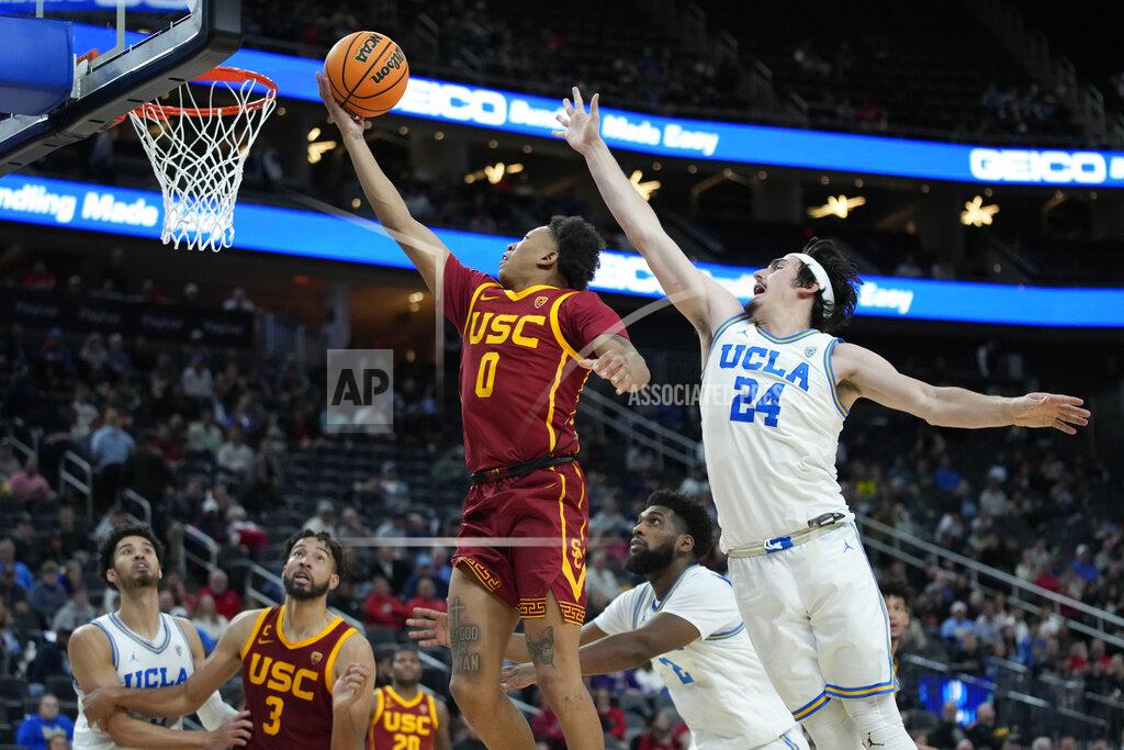 John Locher Southern California's Boogie Ellis (0) shoots around UCLA's Jaime Jaquez Jr. (24) during the second half of an NCAA college basketball game in the semifinal round of the Pac-12 tournament Friday, March 11, 2022, in Las Vegas. (AP Photo/John Locher)