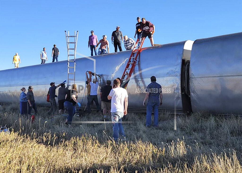 Kimberly Fossen In this photo provided by Kimberly Fossen people work at the scene of an Amtrak train derailment on Saturday, Sept. 25, 2021, in north-central Montana. Multiple people were injured when the train that runs between Seattle and Chicago derailed Saturday, the train agency said. (Kimberly Fossen via AP)