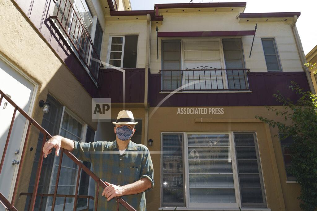 Damian Dovarganes Nathan Long, a video game writer, poses for a picture outside his rental apartment courtyard in Glendale, Calif., Thursday, April 8, 2021. He and his wife, Lili, have been unsuccessful so far in their search for a home in Los Angeles. (AP Photo/Damian Dovarganes)