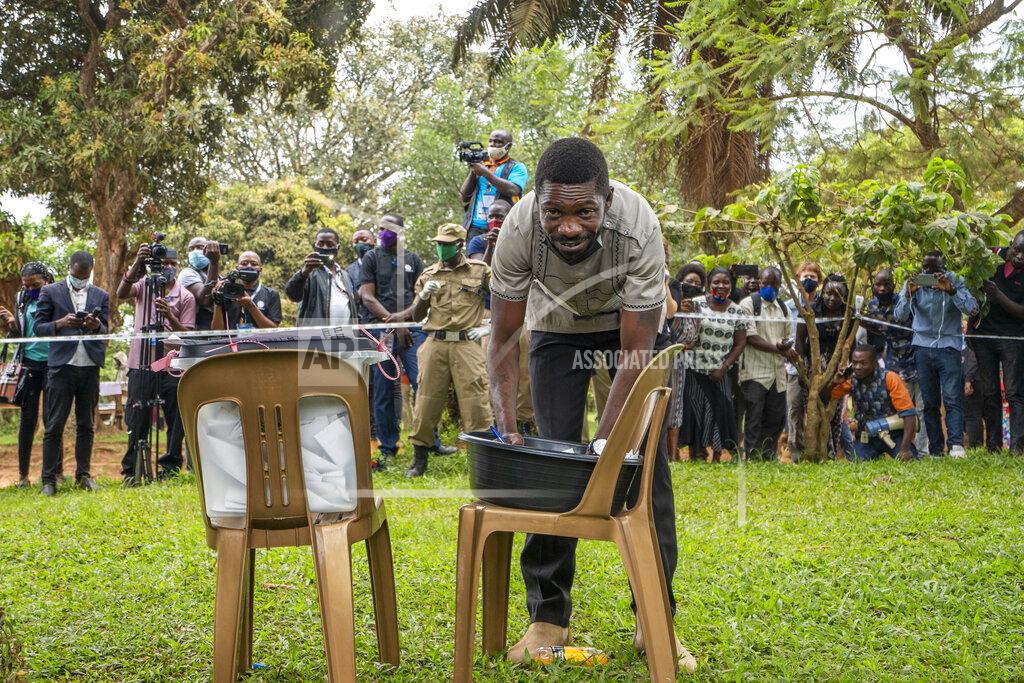 Jerome Delay Uganda's leading opposition challenger Bobi Wine fills his ballot before voting in Kampala, Uganda, Thursday, Jan. 14, 2021. Ugandans are voting in a presidential election tainted by widespread violence that some fear could escalate as security forces try to stop supporters of Wine from monitoring polling stations.(AP Photo/Jerome Delay)