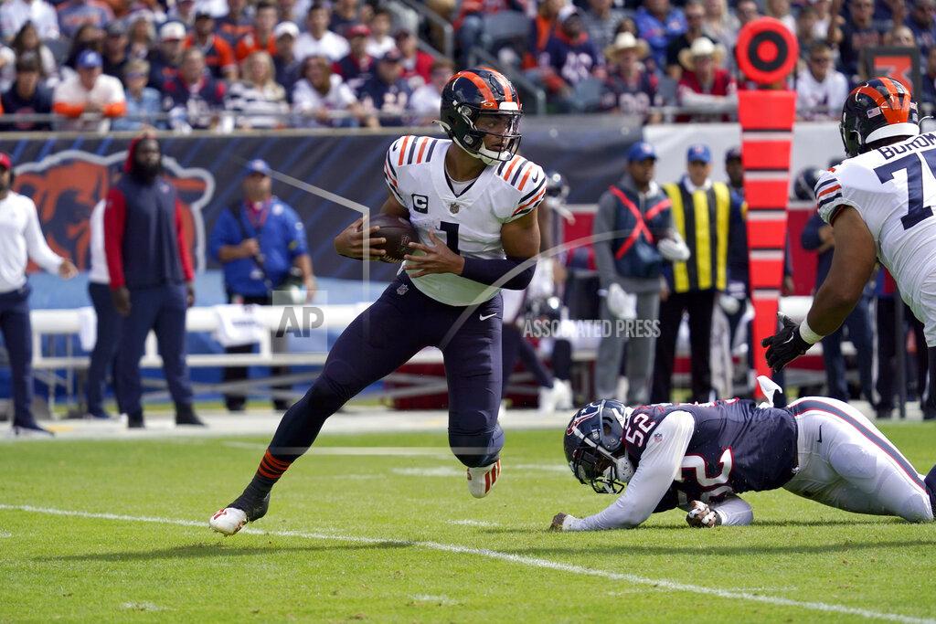 Nam Y. Huh Chicago Bears quarterback Justin Fields (1) scrambles away from Houston Texans defensive end Jonathan Greenard (52) during the first half of an NFL football game Sunday, Sept. 25, 2022, in Chicago. (AP Photo/Nam Y. Huh)