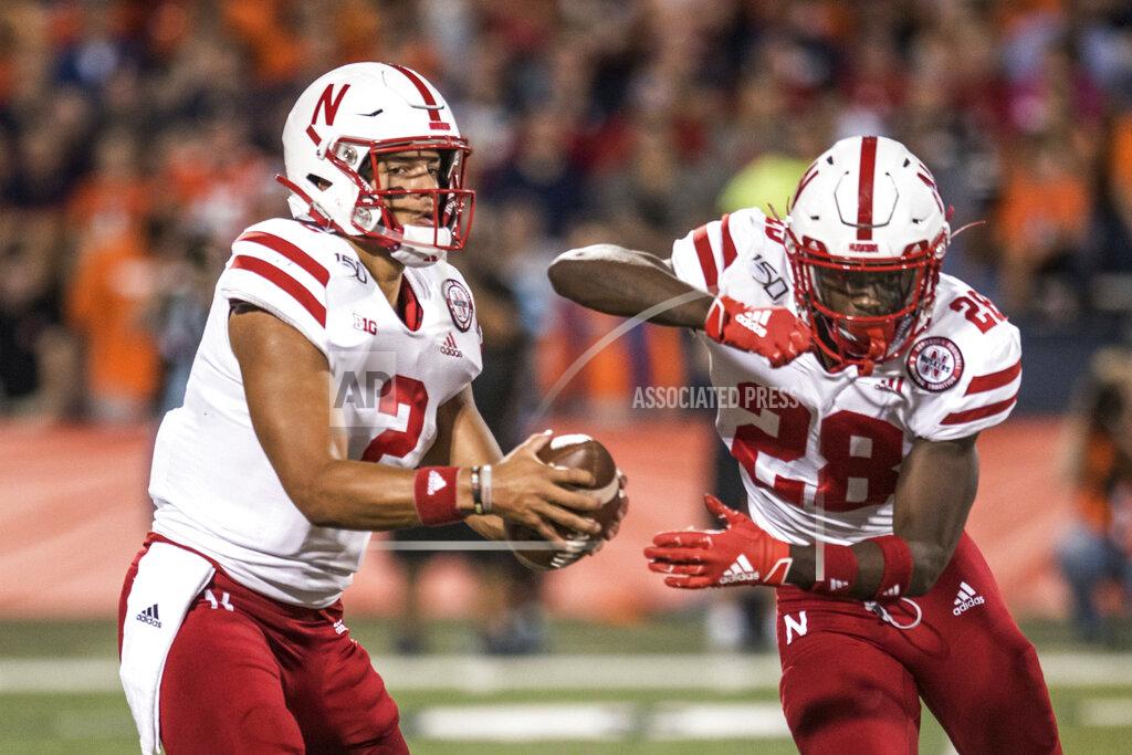 Holly Hart Nebraska quarterback Adrian Martinez (2) fakes a handoff to Maurice Washington (28) in the first half of an NCAA college football game against Nebraska, Saturday, Sept.21, 2019, in Champaign, Ill. (AP Photo/Holly Hart)