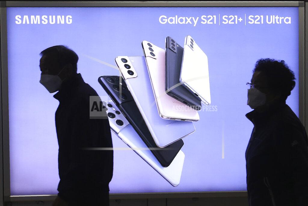 Ahn Young-Joon People pass by an advertisement of Samsung Electronics' Galaxy S21 Series smartphones at a subway station in Seoul, South Korea Wednesday, April 28, 2021. Samsung Electronics said Thursday its operating profit for the last quarter jumped 46% from a year earlier driven by increased sales of smartphones and televisions as its business continues to flourish amid the pandemic. (AP Photo/Ahn Young-joon)
