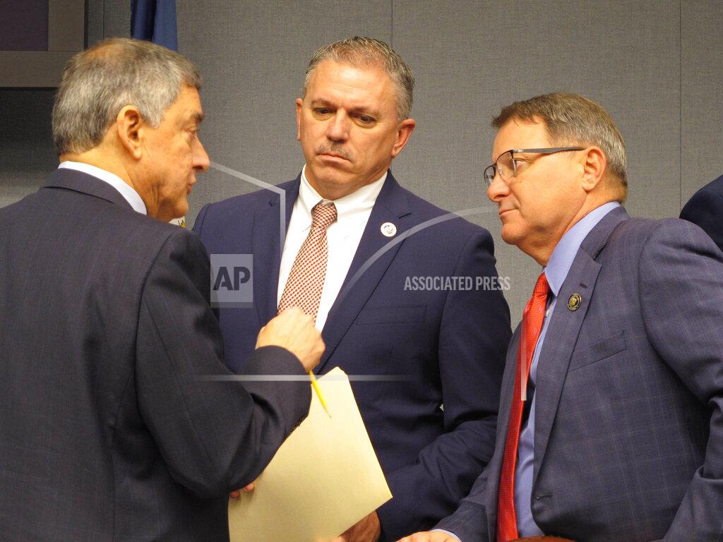 FILE - In a Feb. 7, 2020 file photo, Commissioner of Administration Jay Dardenne, the governor's chief budget adviser, left; House Speaker Clay Schexnayder, R-Gonzales, center; and Senate President Page Cortez, R-Lafayette, speak ahead of a meeting of Louisiana's income forecasting panel in Baton Rouge. Louisiana’s income forecasting panel planned to quantify on Monday, May 11, 2020 just how deeply the coronavirus outbreak has hurt the state’s economy as officials begin to put together next year’s budget. (AP Photo/Melinda Deslatte, File)