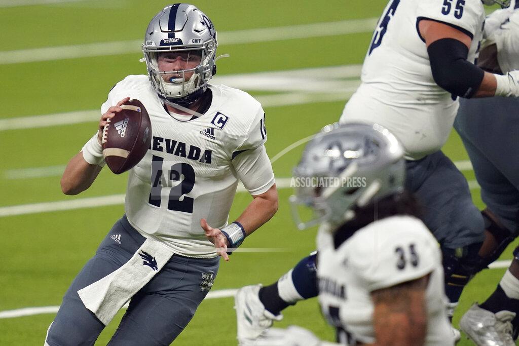 John Locher Nevada quarterback Carson Strong (12) looks for a receiver during the first half of the team's NCAA college football game against UNLV on Saturday, Oct. 31, 2020, in Las Vegas. (AP Photo/John Locher)