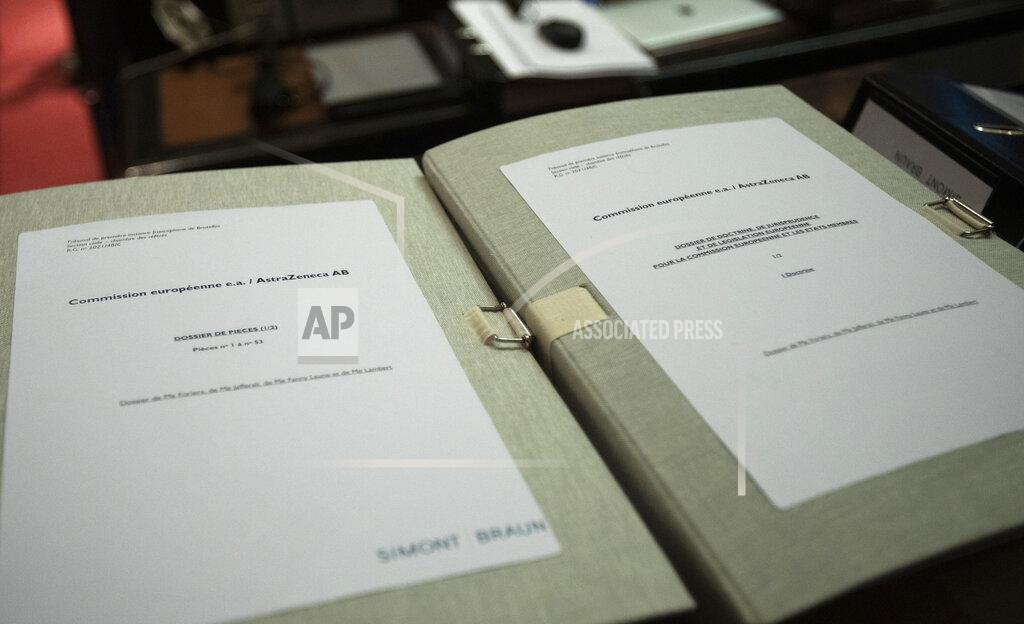 Virginia Mayo Documents are placed on a table in the courtroom prior to a hearing, European Commission vs AstraZeneca, at the main courthouse in Brussels, Wednesday, May 26, 2021. While the EU insists AstraZeneca has breached its contractual obligations, the company says it has fully complied with the agreement, arguing that vaccines are difficult to manufacture and it made its best effort to deliver on time. the European Union's executive branch will try to persuade a Brussels court Wednesday that the case is urgent enough to justify ordering the company to make an immediate delivery of the missing shots. (AP Photo/Virginia Mayo)