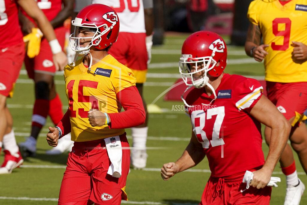 Kansas City Chiefs quarterback Patrick Mahomes (15) and tight end Travis Kelce (87) run during an NFL football training camp Saturday, Aug. 22, 2020, at Arrowhead Stadium in Kansas City, Mo. The Chiefs opened the stadium to 2,000 season ticket holders to watch practice as the team plans to open the regular season with a reduced capacity of approximately 22 percent or normal. (AP Photo/Charlie Riedel)