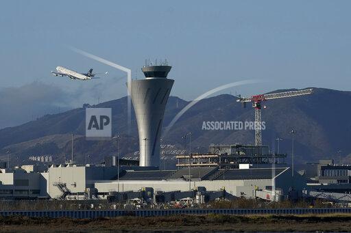 FILE - In this Nov. 24, 2020, file photo, a plane takes off behind the air traffic control tower at San Francisco International Airport in San Francisco. San Francisco is requiring all workers at San Francisco International Airport to get vaccinated against COVID-19. Employees who are exempt must undergo weekly testing. The mandate announced Tuesday, Sept. 21, 2021, applies to roughly 46,000 on-site personnel, including employees of contractors and retail tenants. (AP Photo/Jeff Chiu,File)