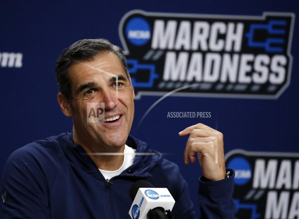 Elise Amendola FILE - In this March 22, 2019, file photo, Villanova head coach Jay Wright speaks during a news conference at the men's college basketball NCAA Tournament in Hartford, Conn. Villanova students are headed back to school this week _ while the Villanova men's basketball coach will be halfway around the world for the next month or so. It has been, and will continue being, a major schedule challenge for Wright as he's tasked with both helping USA Basketball win a gold medal while his college players are on campus getting ready to start their seasons. (AP Photo/Elise Amendola, File)