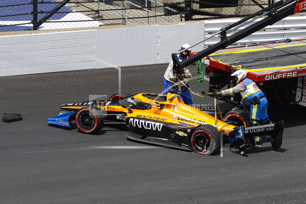 Darron Cummings The car driven by race driver Oliver Askew is removed from the track after making contact with the wall during the IndyCar auto race at Indianapolis Motor Speedway in Indianapolis, Saturday, July 4, 2020. (AP Photo/Darron Cummings)