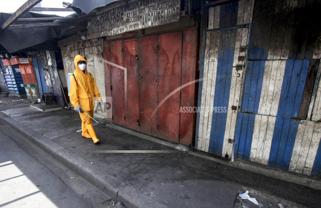 Diomande Ble Blonde A worker sprays disinfectant in the Port Bouet market of Abidjan, Ivory Coast in an attempt to halt the spread of the new coronavirus Monday, March 30, 2020. The new coronavirus causes mild or moderate symptoms for most people, but for some, especially older adults and people with existing health problems, it can cause more severe illness or death. (AP Photo/Diomande Ble Blonde)