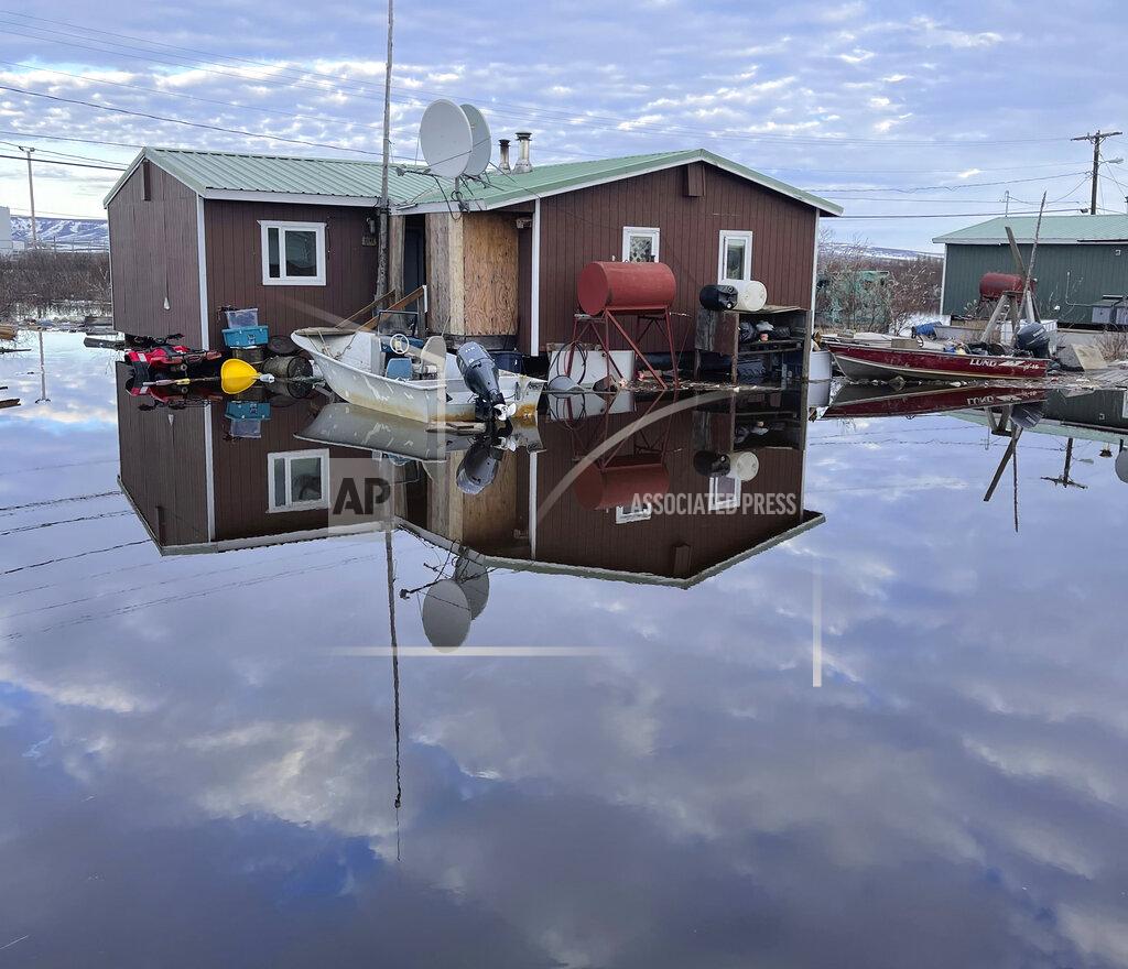 Nathan Hadley Jr. This photo provided by Nathan Hadley Jr. shows flooding in the village of Buckland, Alaska, on Thursday, May 13, 2021. An ice jam on the Buckland River, a half mile below the community, has caused the entire village of about 500 residents in northwest Alaska to be completely inundated. (Nathan Hadley Jr. via AP)