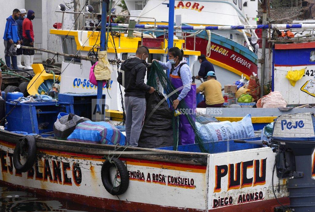Martin Mejia Fishermen prepare their boats before going out to sea in Pucusana, Peru, Monday, Sept. 20, 2021. To compete with the Chinese, the local fishermen of Pucusana assume ever-greater risks, venturing farther out from home and spending as much as a week at sea to haul in what they used to catch in a single day close to shore. (AP Photo/Martin Mejia)