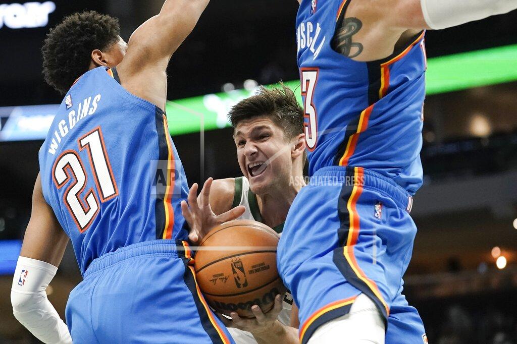 Morry Gash Milwaukee Bucks' Grayson Allen looks to pass between Oklahoma City Thunder's Aaron Wiggins and Mike Muscala during the second half of an NBA preseason basketball game Sunday, Oct. 10, 2021, in Milwaukee. (AP Photo/Morry Gash)