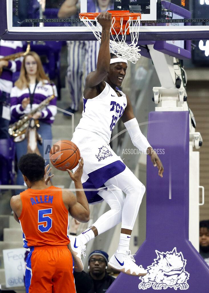 Tony Gutierrez Florida guard KeVaughn Allen (5) watches as TCU forward Kouat Noi (12), of Australia, hangs on the rim after dunking in the first half of an NCAA college basketball game in Fort Worth, Texas, Saturday, Jan. 26, 2019. (AP Photo/Tony Gutierrez)