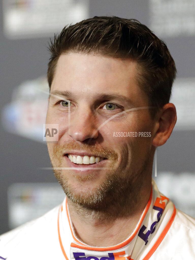 John Raoux Denny Hamlin smiles during NASCAR Daytona 500 auto racing media day at Daytona International Speedway, Wednesday, Feb. 12, 2020, in Daytona Beach, Fla. Picking the car number for Michael Jordan's new NASCAR team was a slam dunk: Bubba Wallace will drive the No. 23 car when the team makes its debut next season. Jordan and Hamlin announced last month they had formed a NASCAR team with Bubba Wallace as the driver. (AP Photo/John Raoux)