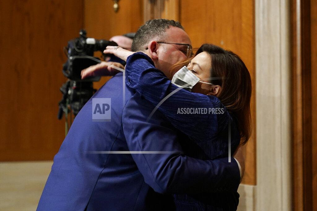 Susan Walsh Education Secretary nominee Miguel Cardona, left, hugs his wife Marissa Cardona, right, at the conclusion of his confirmation hearing before the Senate Health, Education, Labor and Pensions committee on Capitol Hill in Washington, Wednesday, Feb. 3, 2021. (AP Photo/Susan Walsh, Pool)
