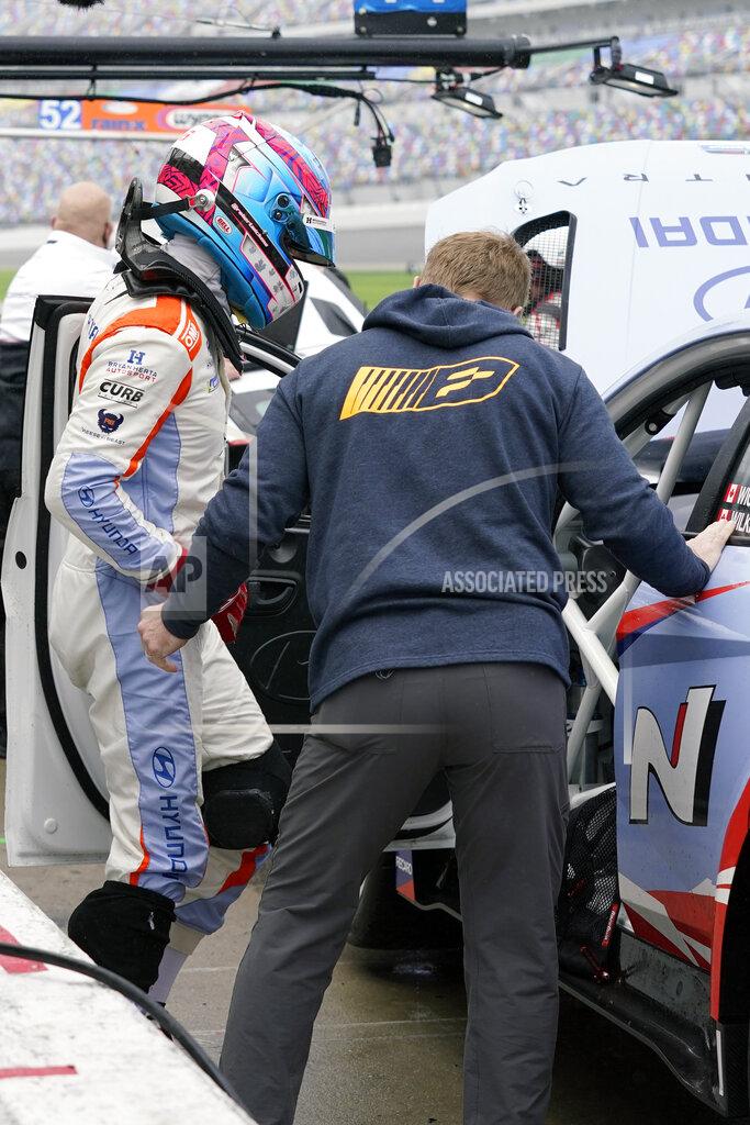 John Raoux Robert Wickens, left, with the help of physical trainer Jim Leo climbs in his car during practice for the Rolex 24 hour auto race at Daytona International Speedway, Thursday, Jan. 27, 2022, in Daytona Beach, Fla. (AP Photo/John Raoux)