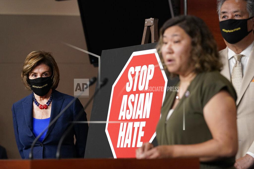 Susan Walsh House Speaker Nancy Pelosi of Calif., left, listens as Rep. Grace Meng, D-N.Y., center, speaks during a news conference on Capitol Hill in Washington, Tuesday, May 18, 2021, on the COVID-19 Hate Crimes Act. Rep. Mark Takano, D-Calif., listens at right. (AP Photo/Susan Walsh)
