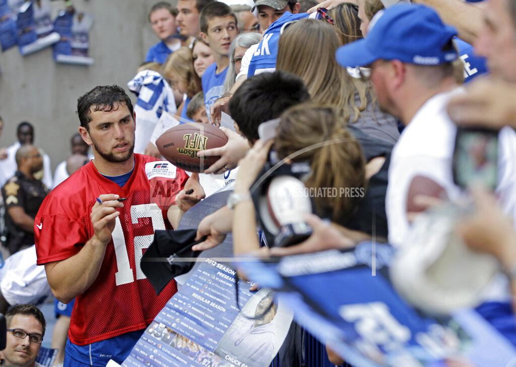 Darron Cummings FILE - In this June 12, 2012, file photo, Indianapolis Colts quarterback Andrew Luck (12) signs autographs for fans following the NFL football team's practice in Indianapolis. Luck watched one last game from the sideline Saturday, Aug. 24, 2019, in Indianapolis. Then he said goodbye to the NFL. The quarterback heard boos as he walked away from the field, then walked to the podium and made the surprise decision official. The oft-injured star is retiring at age 29. (AP Photo/Darron Cummings, File)