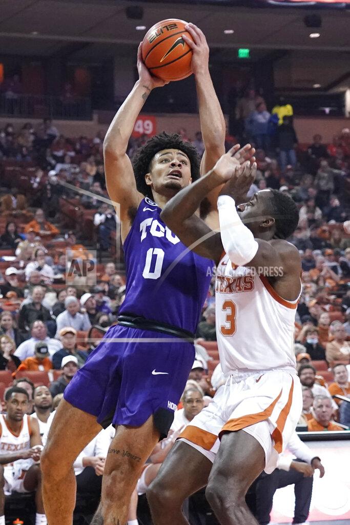 Chuck Burton TCU guard Micah Peavy (0) shoots against Texas guard Courtney Ramey (3) during the first half of an NCAA college basketball game in Austin, Texas, Wednesday, Feb. 23, 2022. (AP Photo/Chuck Burton)