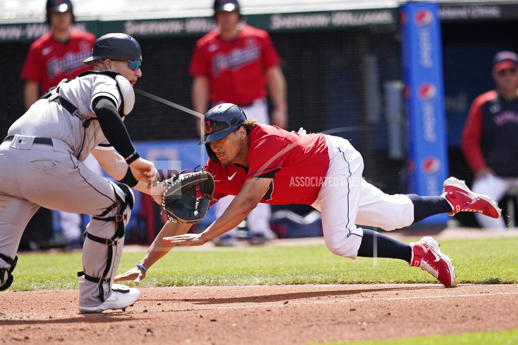 Tony Dejak Cleveland Indians' Josh Naylor, right, slides safely into home plate as Chicago White Sox catcher Zack Collins waits for the ball in the fourth inning of the first baseball game of a doubleheader, Monday, May 31, 2021, in Cleveland. (AP Photo/Tony Dejak)