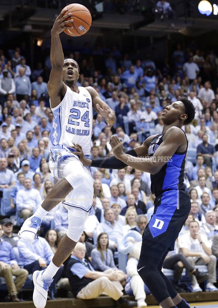Gerry Broome North Carolina's Kenny Williams (24) drives to the basket while Duke's RJ Barrett defends during the first half of an NCAA college basketball game in Chapel Hill, N.C., Saturday, March 9, 2019. (AP Photo/Gerry Broome)