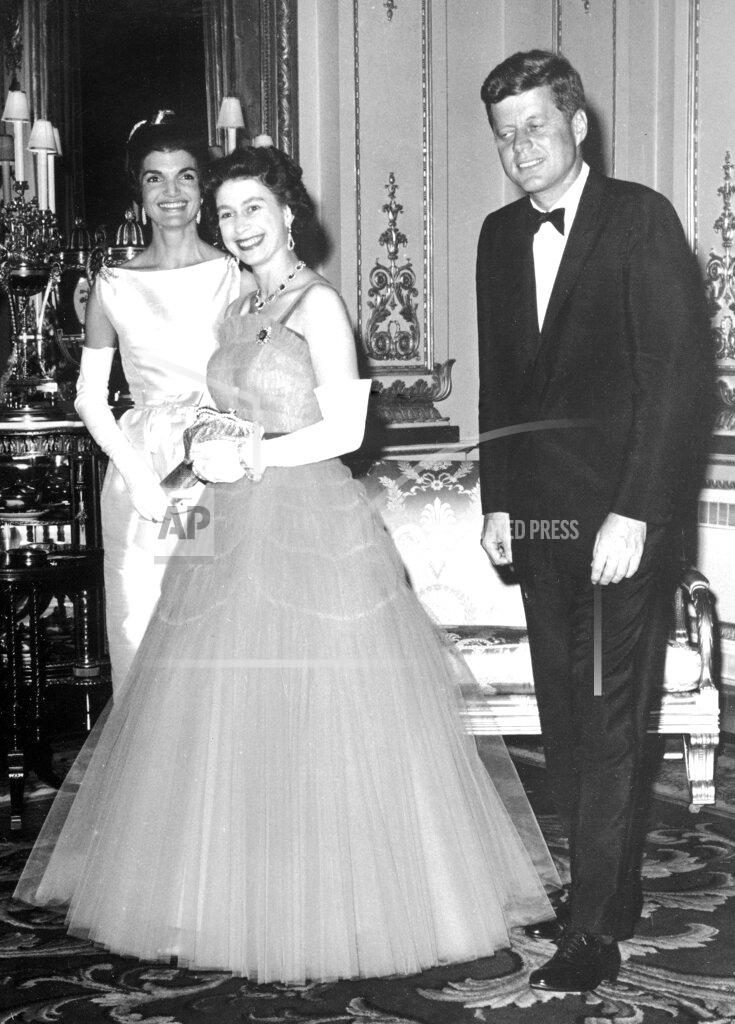 Anonymous FILE - In this file photo dated June 5, 1961, Queen Elizabeth II, center, walks with U.S. President John F. Kennedy, right, and his wife Jacqueline Kennedy, as they enter an ante-room in Buckingham Palace, London, before a dinner given by the Queen in honour of the visiting President and his wife. (AP Photo, File)