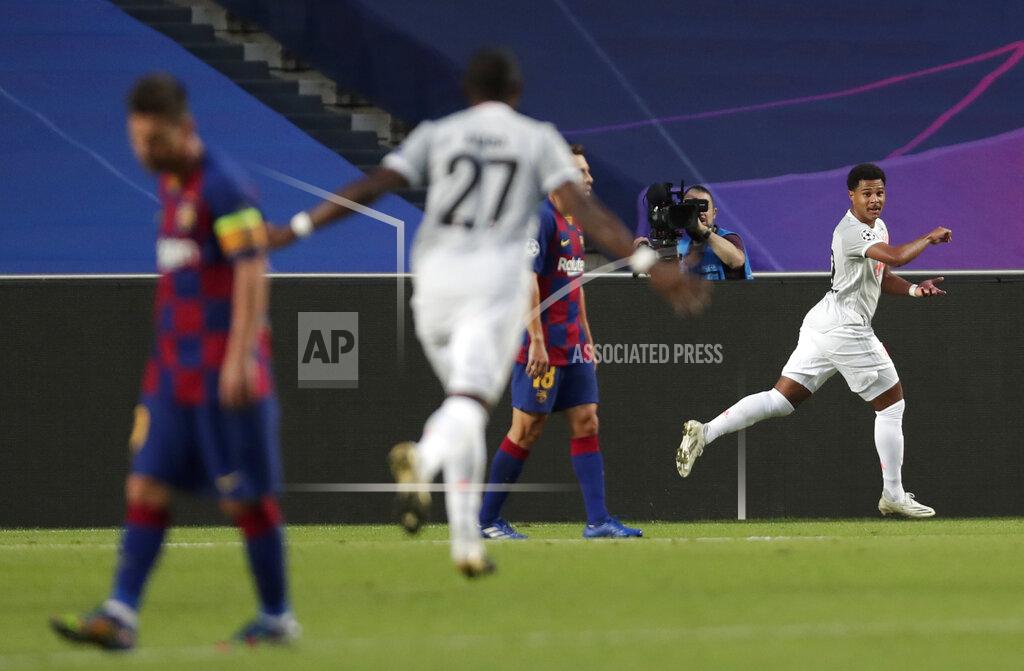 Manu Fernandez Bayern's Serge Gnabry, right, celebrates after scoring his sides third goal during the Champions League quarterfinal match between FC Barcelona and Bayern Munich at the Luz stadium in Lisbon, Portugal, Friday, Aug. 14, 2020. (AP Photo/Manu Fernandez/Pool)