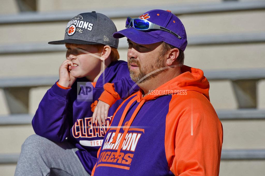 Richard Shiro Kevin Fields and his 10-year old son Jackson watch Clemson players warm up before the start of an NCAA college football game against Louisville Saturday, Nov. 3, 2018, in Clemson, S.C. (AP Photo/Richard Shiro)