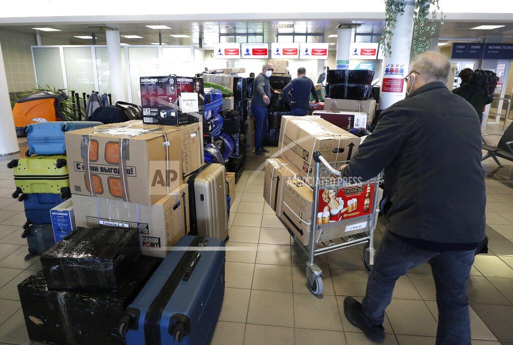 Petr David Josek People check in luggages at the Vaclav Havel airport after a Russian special government plane landed in Prague, Czech Republic, Monday, April 19, 2021. Czech Republic is expelling 18 diplomats identified as spies over a 2014 ammunition depot explosion. On Saturday, April 17, 2021, Prime Minister Andrej Babis said the Czech spy agencies provided clear evidence about the involvement of Russian military agents in the massive explosion that killed two people. (AP Photo/Petr David Josek)
