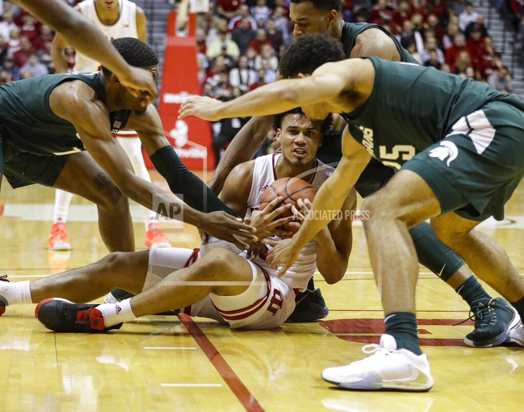 Darron Cummings Indiana forward Justin Smith (3) is tied up by Michigan State forward Aaron Henry (11) and forward Malik Hall (25) in the first half of an NCAA college basketball game in Bloomington, Ind., Thursday, Jan. 23, 2020. (AP Photo/Darron Cummings)