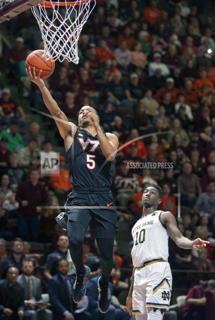 Don Petersen Virginia Tech guard Justin Robinson (5) shoots a basket past Notre Dame guard TJ Gibbs (10) during the second half of an NCAA college basketball game Tuesday, Jan. 1, 2019, in Blacksburg, Va. Virginia Tech won 81-66. (AP Photo/Don Petersen)