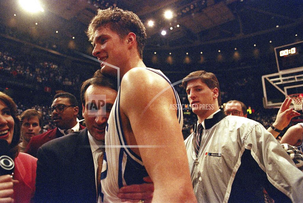 Amy Sancetta FILE - In this March 28, 1992, file photo, Duke University basketball head coach Mike Krzyzewski hugs his star center Christian Laettner after Duke defeated Kentucky in overtime 104-103 to win NCAA East Regional Final in Philadelphia. (AP Photo/Amy Sancetta, File)