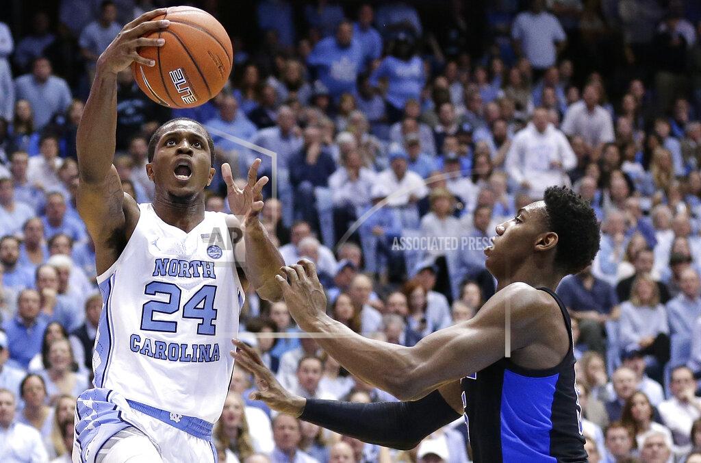 Gerry Broome North Carolina's Kenny Williams (24) drives to the basket as Duke's RJ Barrett defends during the first half of an NCAA college basketball game in Chapel Hill, N.C., Saturday, March 9, 2019. (AP Photo/Gerry Broome)